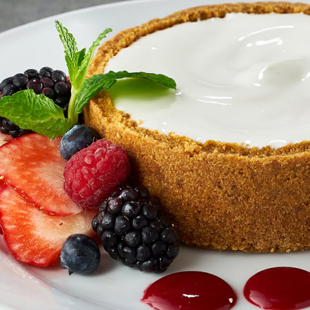 Cream cheese dessert with fresh berries and fruit garnishes at Ruth's Chris Steak House.