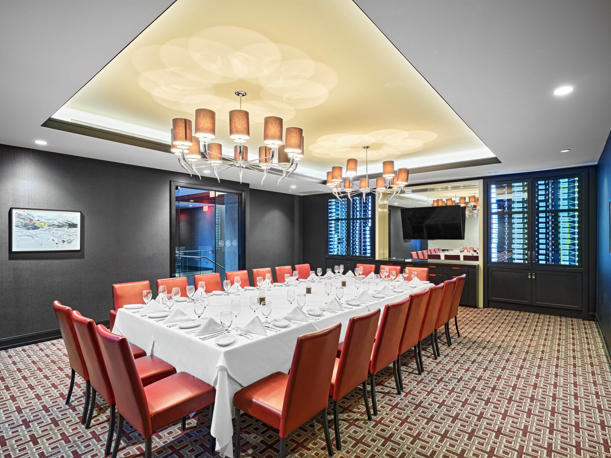 Elegant private dining room at Ruth's Chris Steak House with a long table, fine glassware, and sophisticated decor for special occasions and corporate events.